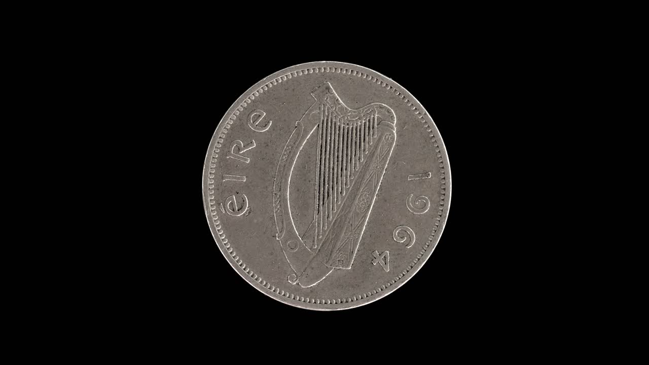 Ireland 1964 sixpence coin obverse with Irish harp and date rotating on black background
