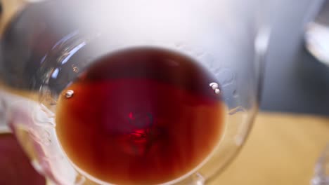 close-up of red wine swirling in glass