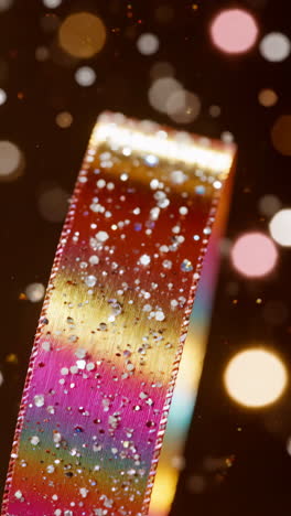 close-up of a festive glittery rainbow ribbon with bokeh lights