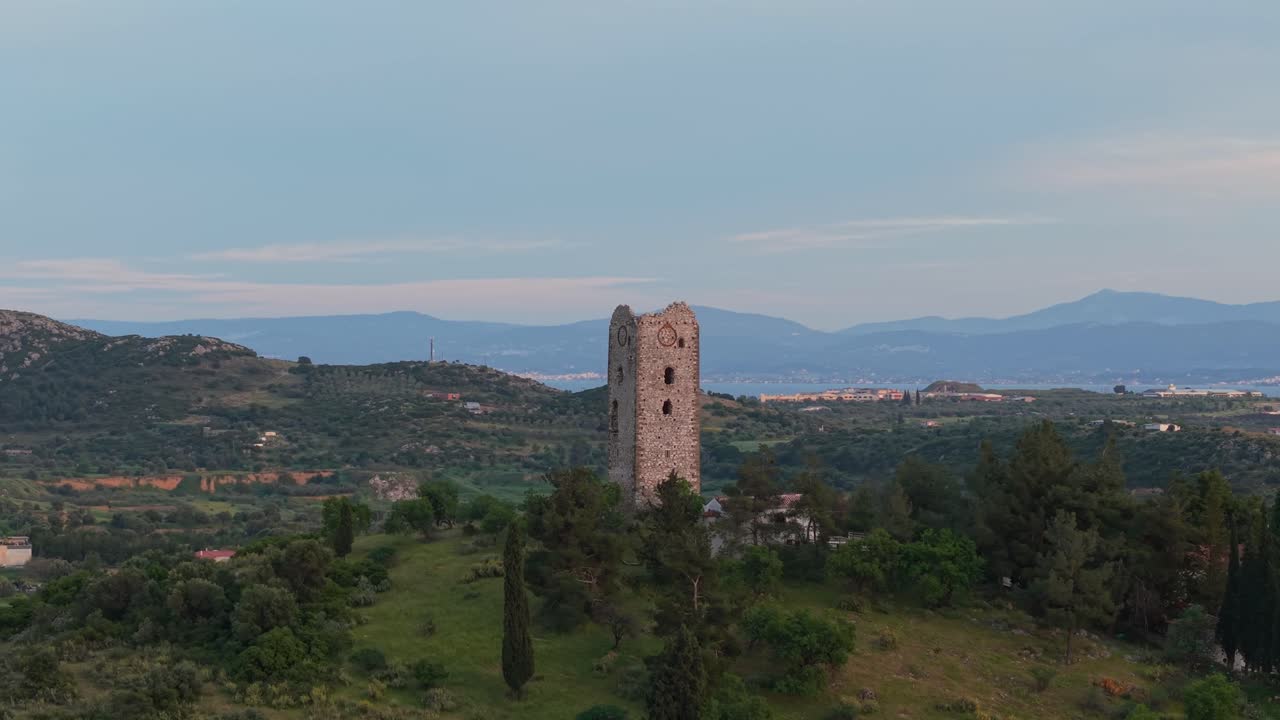 Aerial orbit around a stone tower located in the historic Lilantio Plain, with the Euboean Gulf stretching out in the background. A landscape shaped by time and myth