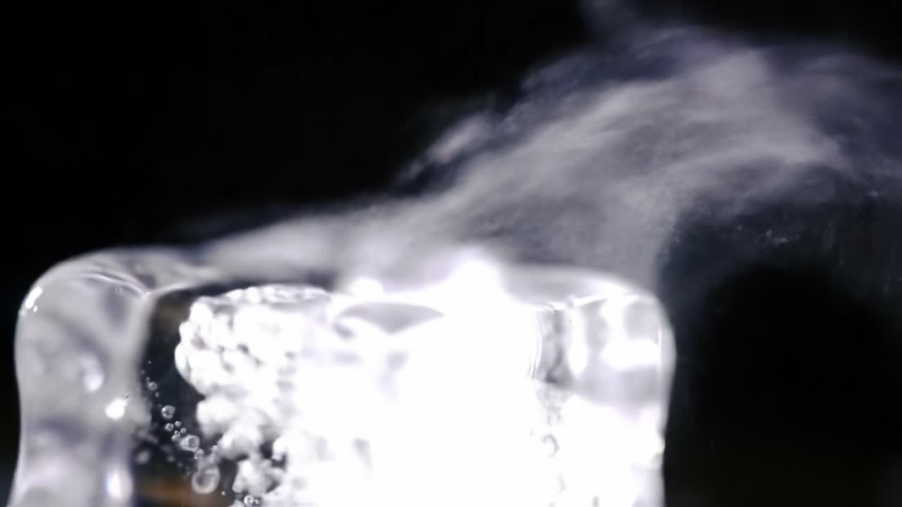 Captivating Bubbles Rise From a Clear Glass Indoors During a Warm Evening