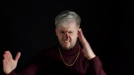 brave handsome man standing in defensive karate posture punching to camera, threatening to attack