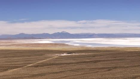 Aerial-Drone-Tracking-Orbit-Overlooking-Dirt-Road-Near-The-Salinas-Grandes-of-Jujuy-and-Salta-Provinces,-Argentina