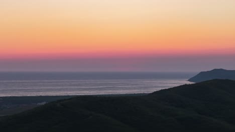 colorful sky sunset timelapse over adriatic sea and dark shore hillside