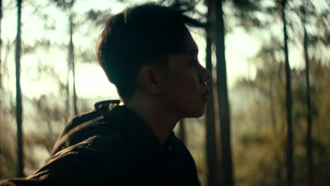 man in a forest profile view