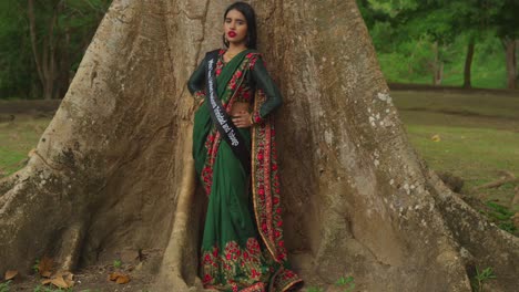 A-young-girl-enjoys-a-day-at-a-tropical-park-in-the-Caribbean,-dressed-in-traditional-Indian-attire