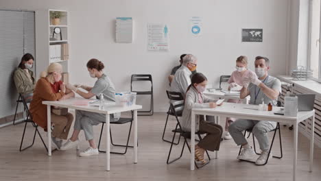 people in busy vaccination room