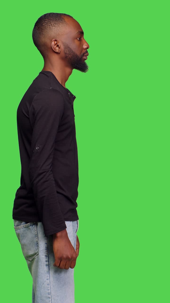 Vertical video: Profile of male model feeling pensive thinking about information