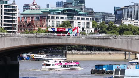 a boat travels under a bridge in london