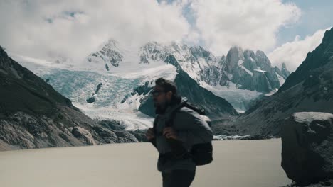 Hiker-With-Backpack-Walking-In-The-Trail-Passing-By-Laguna-Torre,-Cerro-Torre-And-Glacier-In-El-Chalten,-Argentina