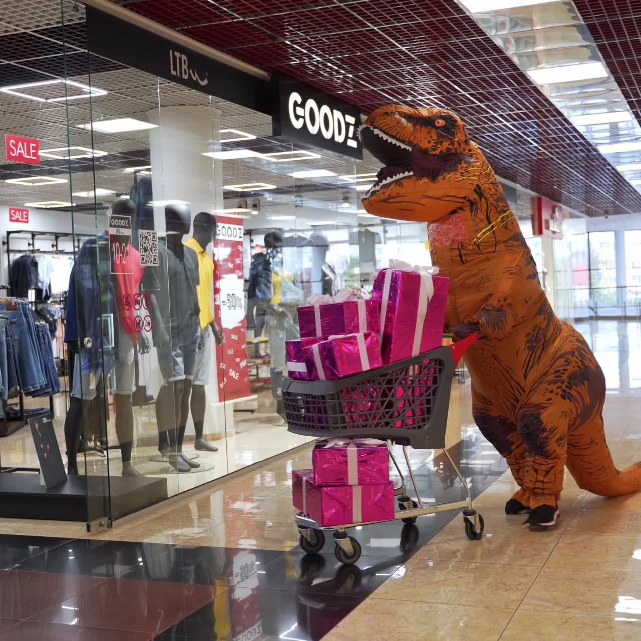 Person in dino costume in mall. Rex costume walking and shopping