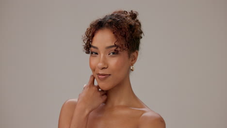 beautiful young woman with curly hair smiling and looking at camera