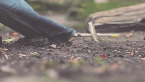 person walking through mud