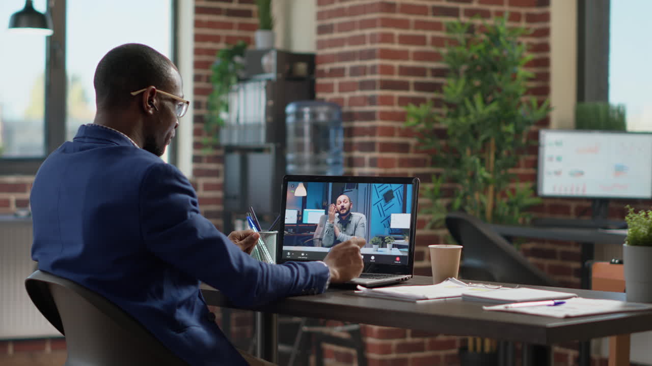 Financial analyst using online teleconference to meet with project leader