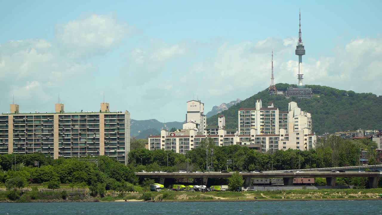 n namsan torre de seúl en un día soleado y nublado, vista desde la orilla del río han en verano
