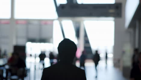 people moving in a modern, bright public hallway