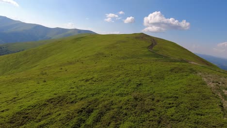 aerial flight over green hill mountains. fpv dynamic drone shot