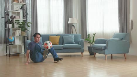 asian man show skill with soccer ball in living room, soccer freestyle