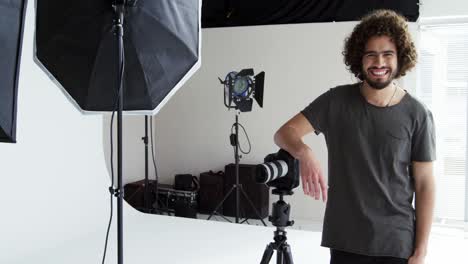 photographer standing with digital camera in studio