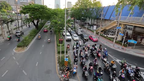 motorcycles and cars navigating a city junction