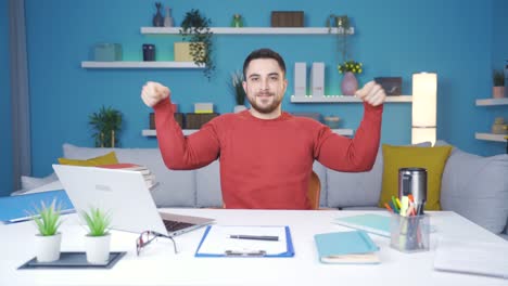 Young-man-showing-how-to-exercise-in-the-office.-Doing-wrist-exercises.