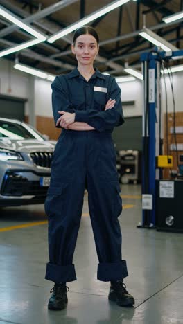 skilled female mechanic standing confidently in modern automotive repair shop, embodying professional expertise and mastery of automotive service technical skills