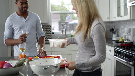 Mixed-race-couple-preparing-meal-in-their-kitchen,-close-up,-shot-on-R3D