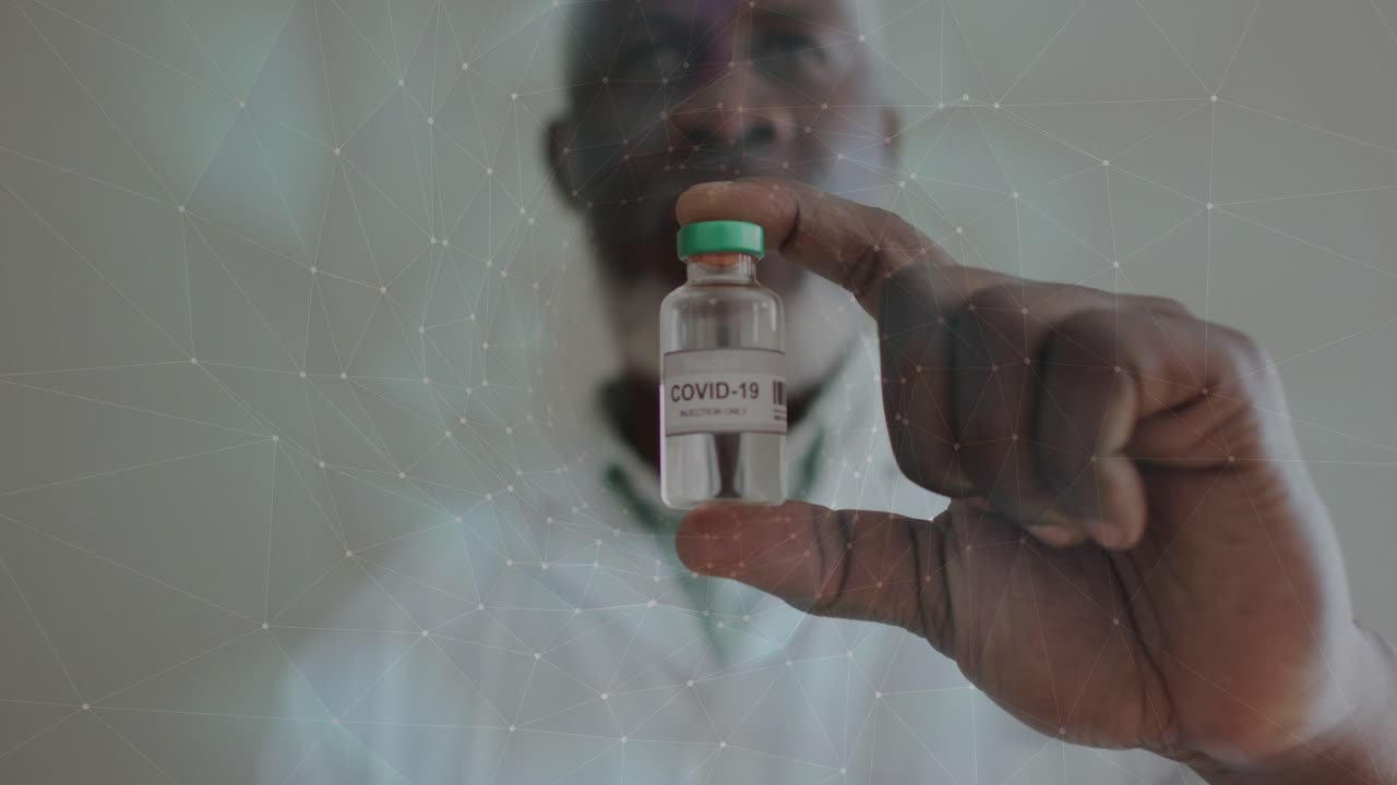 Man bringing COVID-19 vial forward, holding and steadying for health inspection with nebula overlay