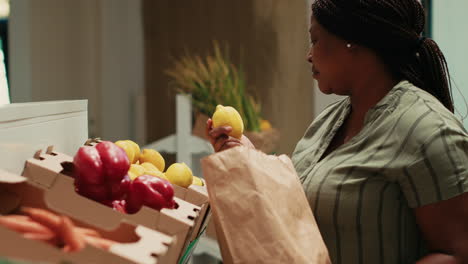 customer smelling fresh ripe lemons from crates