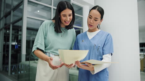 two healthcare professionals shaking hands in a hospital