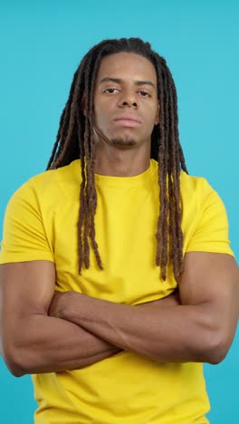 man with dreadlocks and arms crossed