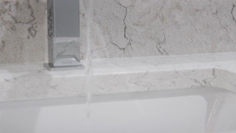 water pouring from a fresh faucet - remodeled bathroom