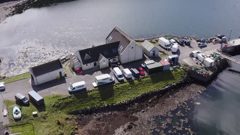 dynamic drone shot of the community centre on the isle of scalpay, an island near the isles of harris and lewis on the outer hebrides of scotland