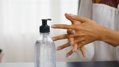 close up of woman using hand sanitizer