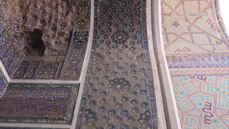 looking up at detailed ceiling of archway door to islamic mosque in samarkand, uzbekistan along the historic silk road