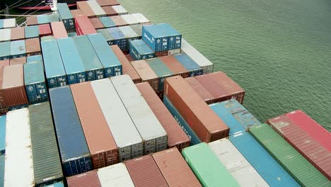 Colourful-containers-on-a-cargo-container-ship,-looking-down-to-the-loading-area