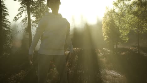 young woman standing alone outdoor with wild forest mountains