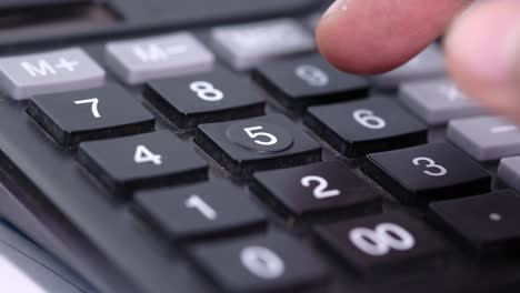 person pressing 5 on a calculator