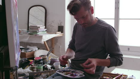 Artist Putting Oil Paint On Palette In Studio Shot On R3D