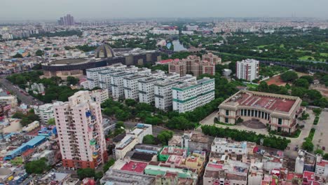 kalaivanar arangam, narayana arihant ocean tower with government medical college and multi super speciality hospital at wallahjah road, chennai, tamil nadu, india. daytime, semi orbit, drone shot, 4k.
