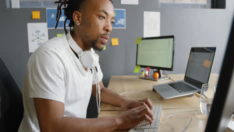 male executive working on computer at desk in office 4k