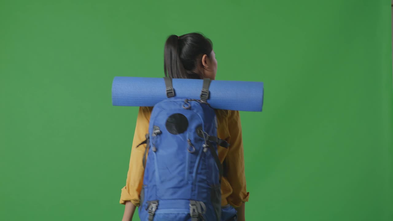 Woman with Backpack and Yoga Mat on Green Screen