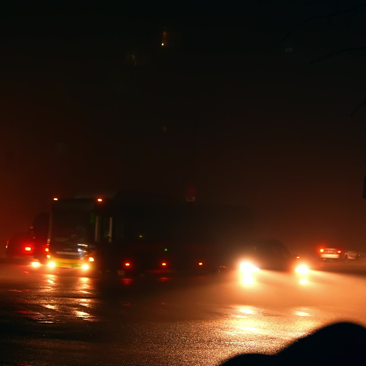 Energy blackout in the modern city. Road traffic by the dark streets lit only with the lamps of headlights