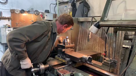 turner behind a turning and milling machine.