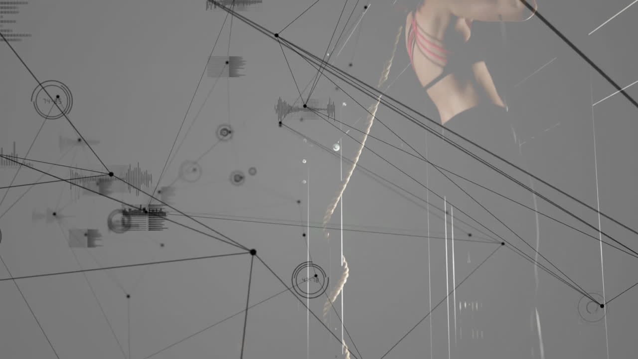 Woman climbing rope in fitness studio, with floating digital nodes connecting data charts
