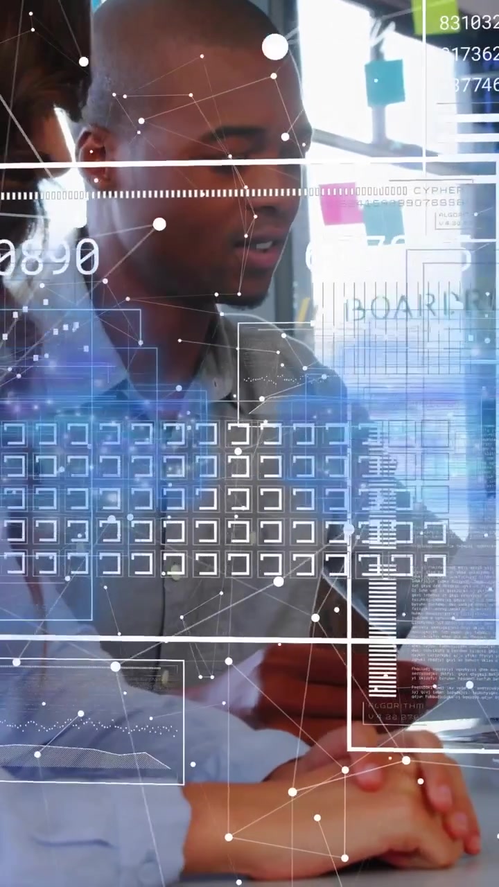 Man tapping device, causing AR HUD updating while woman leaning in, reviewing work data