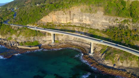 famous sea cliff bridge at the grand pacific drive with cars traveling during summer in new south wales, australia