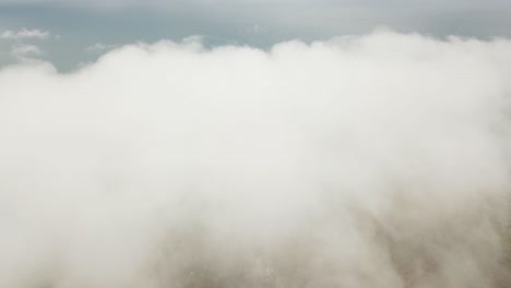 Drone-aerial-flying-towards-and-into-white-clouds