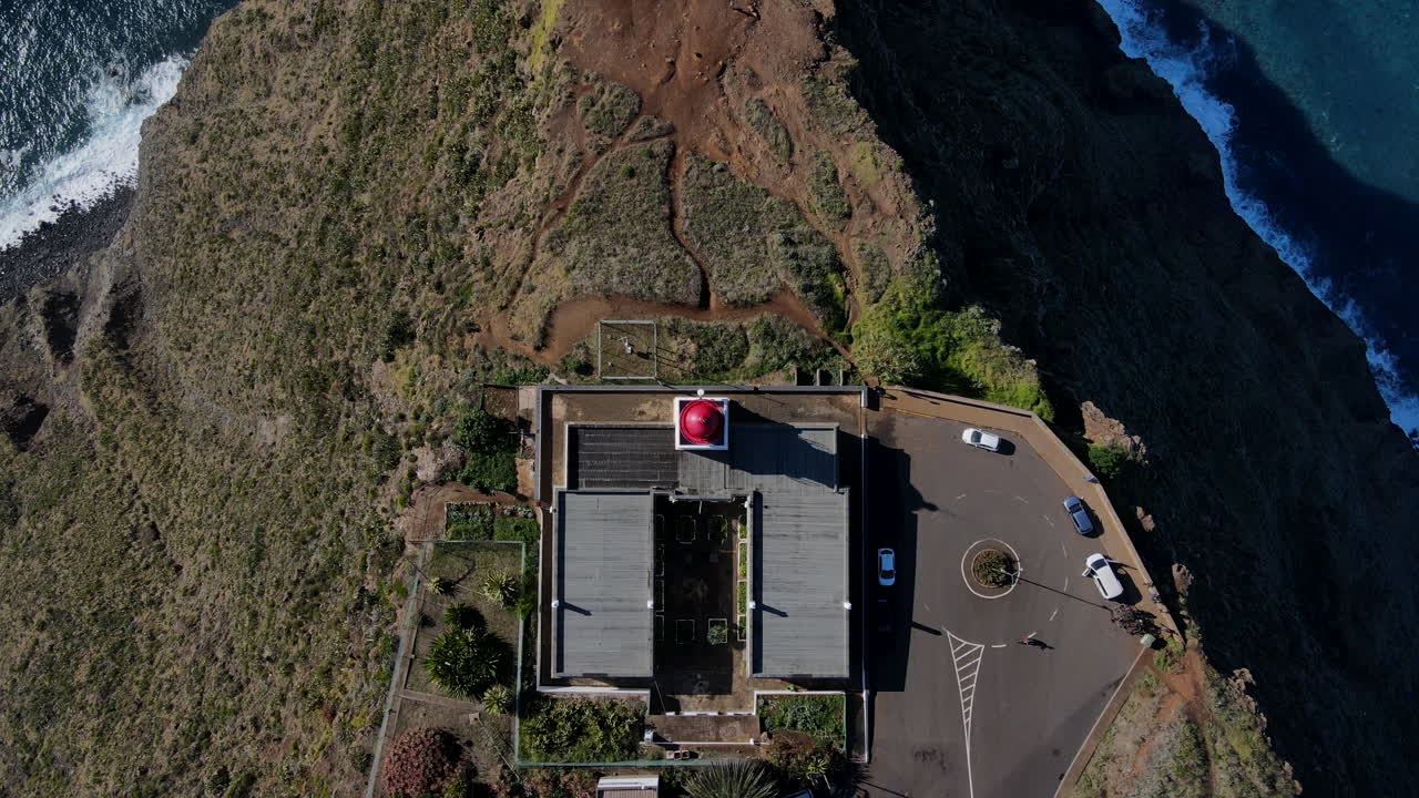 Cenital views of Madeira island from Ponta do Pargo Lighthouse - A shot that shows the lighthouse and the surrounding landscape of the island from a high perspective