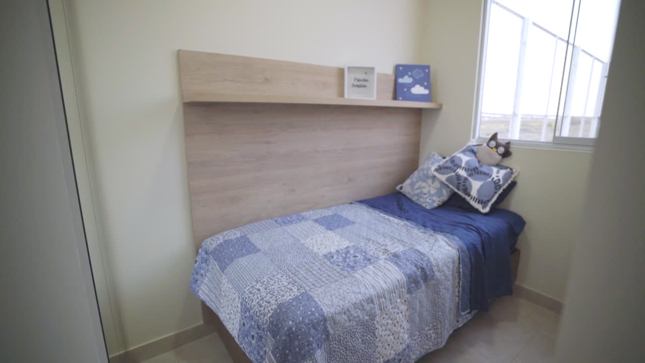 Slow motion shot of a boy's room with a bed and decorations inside a house